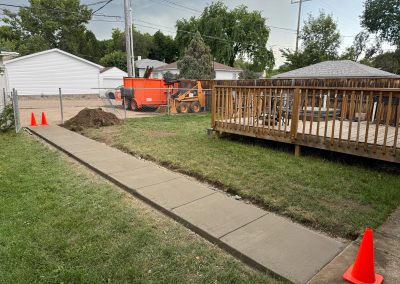 Newly poured concrete sidewalk and pathway as part of residential landscaping project